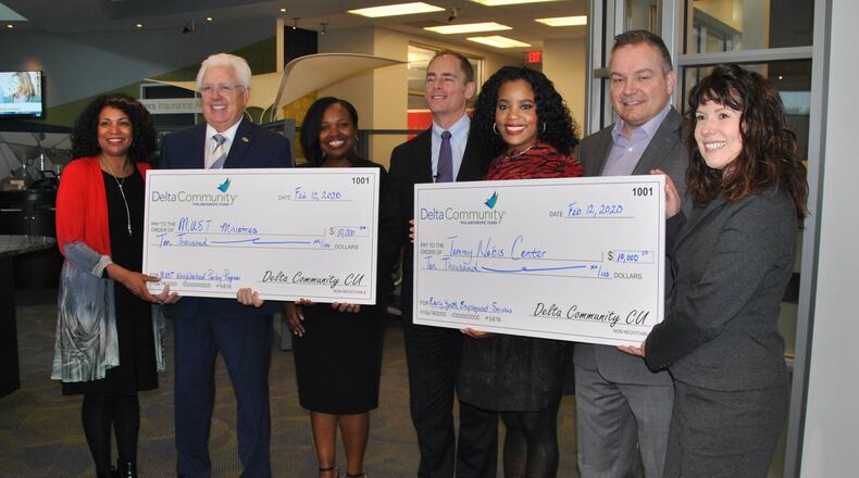 From left to right are: Yvonne Byars, director of the MUST Ministries Neighborhood Pantry Program; Dr. Ike Reighard, MUST Ministries CEO; Lakeisha Chamber, Delta Community Marietta Branch Manager; Hank Halter, Delta Community CEO; Reina Short, Community Development Manager; Dave Ward, Tommy Nobis Center CEO; Monica Oliveira, Nobis Center Development Specialist. Credit: Delta Community Credit Union