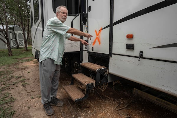 Curtis Beal motions to how high waters rose while describing the flash flood he experienced at Cedar Stays RV Park in Marble Falls, Texas, Monday, July 7, 2025. (Mikala Compton /Austin American-Statesman via AP)