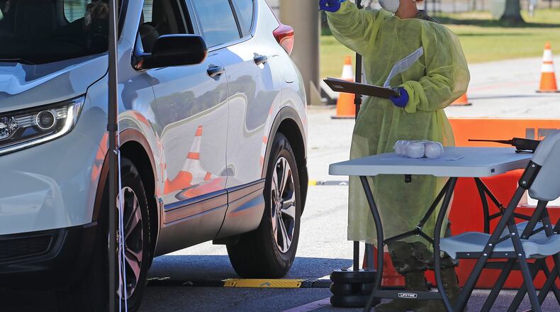 A National Guard soldier from the 170th Military Police Battalion checks a person into the Cobb County CO-VID 19 testing site at Jim R. Miller Park in Marietta, Georgia, on Friday, April 17, 2020. Christina Matacotta / for the AJC
