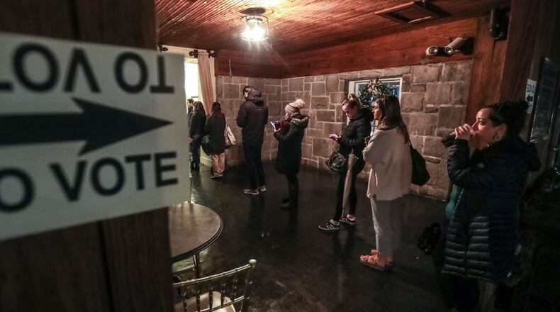 Voters lined up on Tuesday, Dec. 6, 2022 at the Park Tavern in Atlanta. (John Spink / John.Spink@ajc.com)