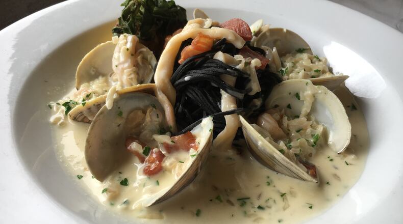 Black Spaghetti Vongole from Portofino in Buckhead. Chef Matt Marcus likes to have a black pasta dish on the menu at all times. This version tops squid ink pasta with chopped Sapelo Island clams cooked with white wine and pancetta. Photo credit: Andrew Thomas Lee