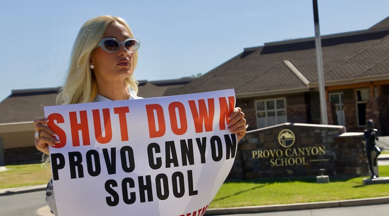 Paris Hilton protests outside the Provo Canyon School, where she says she suffered abuse as a teen, Monday, June 15, 2026, in Springville, Utah. (AP Photo/Hannah Schoenbaum)