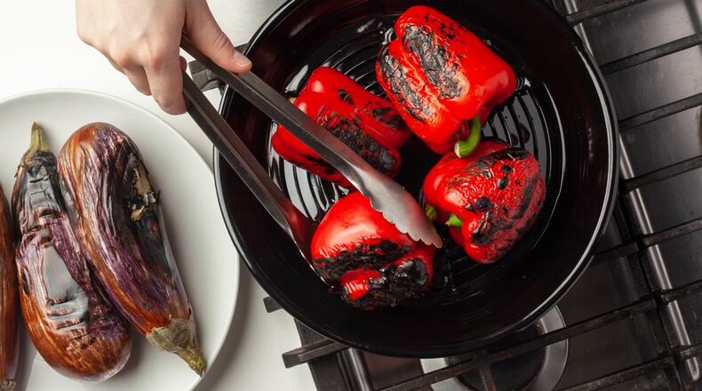 A Turkish vegetable roasting tray, known as a kozmatik, is a thin, shallow metal bowl with slits cut into the bottom. The tray fits on the grate of a gas stovetop, and offers an easy way to char vegetables without lighting up a grill or heating the oven. (Courtesy of Milk Street)