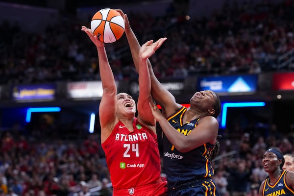 Atlanta Dream forward Brionna Jones (24) tries to shoot overIndiana Fever forward Aliyah Boston (7) in the second half of a WNBA basketball game in Indianapolis, Tuesday, May 20, 2025. (AP Photo/Michael Conroy)