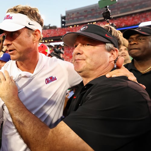 Mississippi head coach Lane Kiffin, left, and Georgia head coach Kirby Smart, right, embrace at midfield after an NCAA college football game, Saturday, Oct. 18, 2025, in Athens, Ga. (AP Photo/Colin Hubbard)