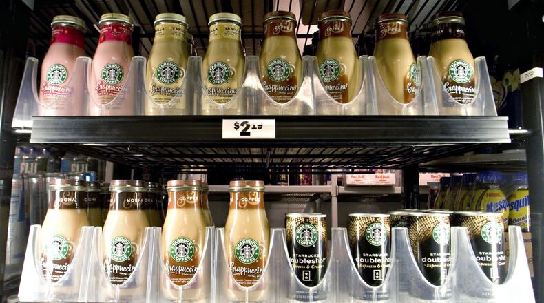 Coke and Dunkin’ Donuts are teaming to offer a bottled coffee drink to compete with Starbucks Frappuccino drinks distributed through an expanded venture with Pepsi. Photographer: JB Reed/ Bloomberg News