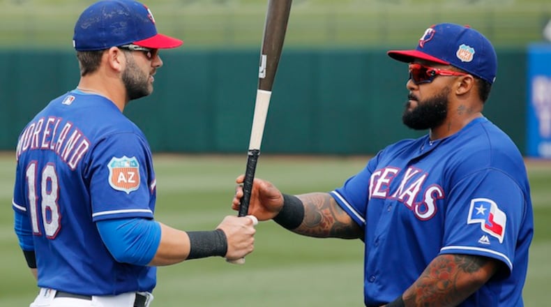 Texas Rangers' Mitch Moreland (18) talks with Prince Fielder, right, prior to a spring training baseball game against the San Francisco Giants Monday, March 7, 2016, in Surprise, Ariz. (AP Photo/Ross D. Franklin)