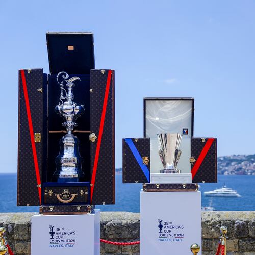 FILE - The America's Cup trophy, left, and Louis Vuitton Cup trophies are seen during the presentation of the 38th America's Cup, at the Castel dell'Ovo in Naples, southern Italy, Wednesday, May 28, 2025. (Alessandro Garofalo/LaPresse via AP, File).