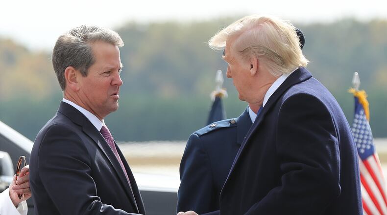 Georgia Gov. Brian Kemp greets President Donald Trump at Dobbins Air Force Base on Nov. 8, 2019, in Marietta. (Curtis Compton/ccompton@ajc.com)