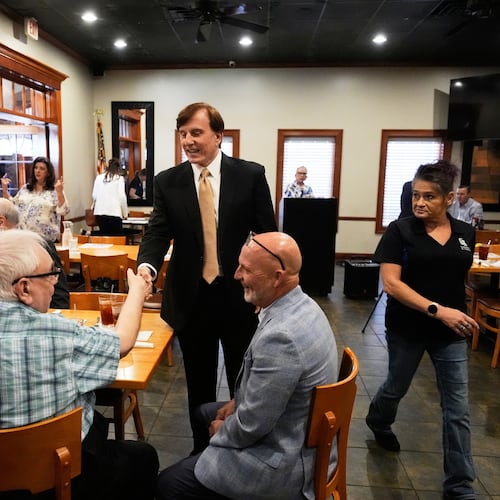 FILE - John Fleming, a U.S. Senate candidate, current Louisiana treasurer and former Republican House representative of Louisiana, greets supporters at a Ronald Reagan Newsmaker Luncheon in Baton Rouge, La., May 12, 2026. (AP Photo/Gerald Herbert, File)