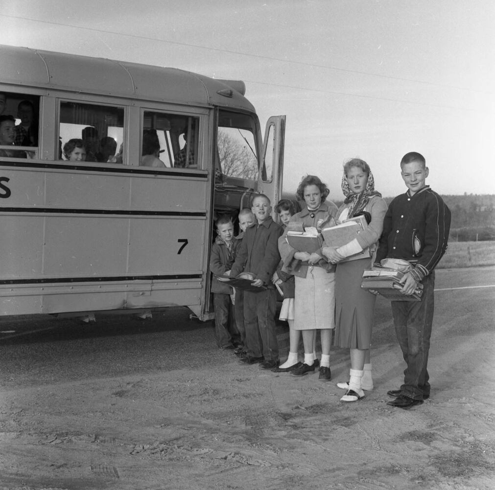 Family o boarding the school bus, 1959.