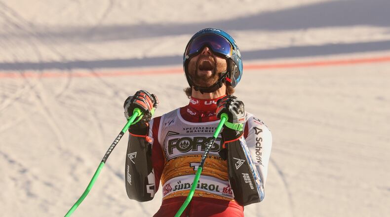 Austria's Marco Schwarz celebrates at the finish area of an alpine ski, men's World Cup Giant slalom, in Alta Badia, Italy, Sunday Dec. 21, 2025. (AP Photo/Alessandro Trovati)
