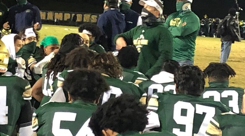 Grayson coach Adam Carter talks to his team after its 30-6 win over Harrison in the Class 7A playoffs.