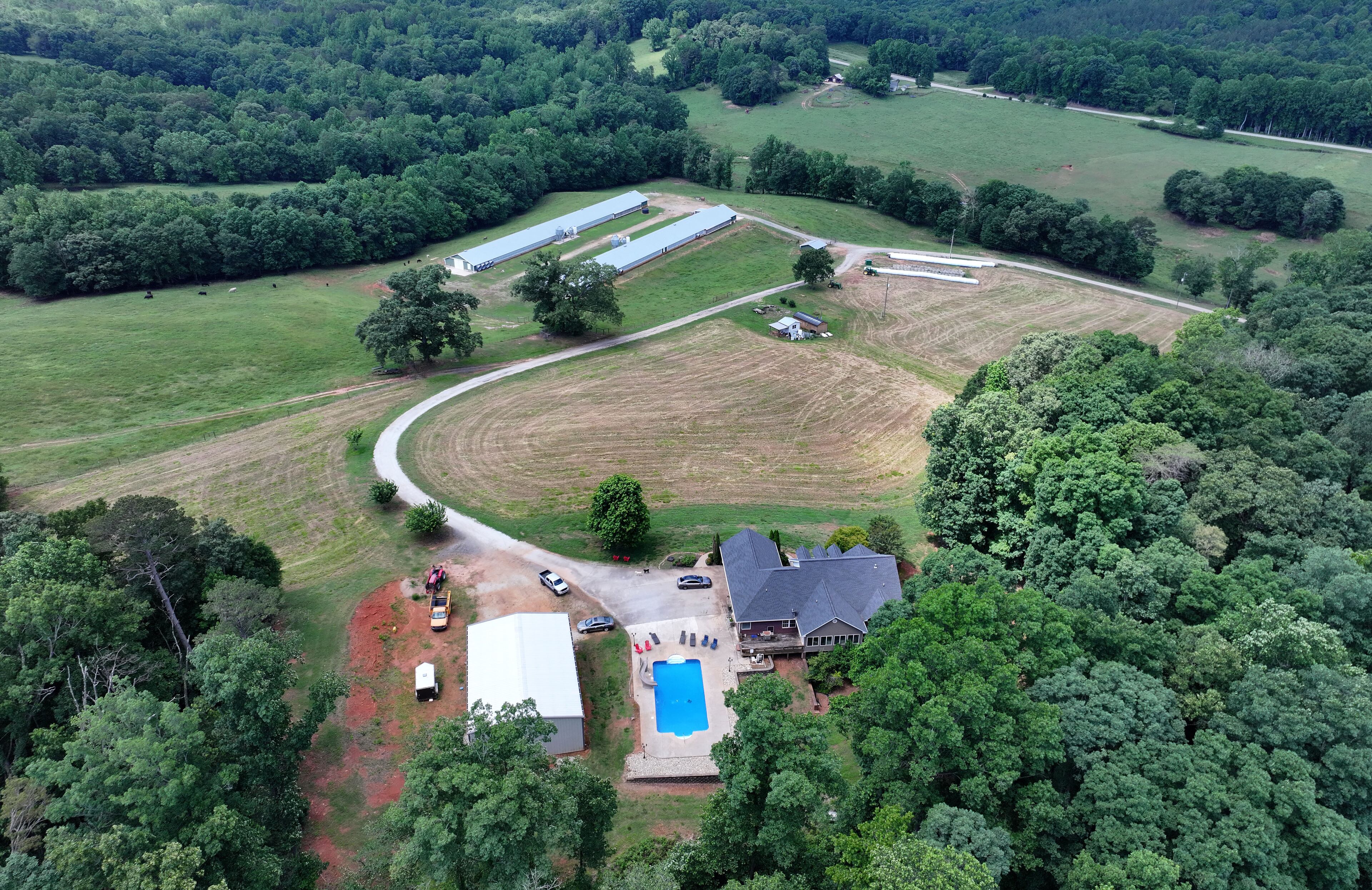 An aerial photo shows the property of Banks County Sheriff Carlton Speed, Wednesday, May 21, 2025, in Carnesville. The boundary between Banks and Franklin moved to the east several years ago, allowing the Banks sheriff to assert he lives in the county. The boundary between Banks and Franklin runs behind his house and near a swimming pool. (Hyosub Shin / AJC)