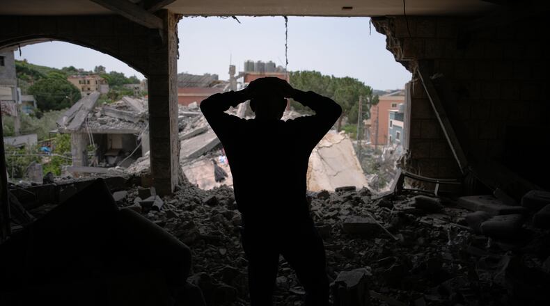 Assem Abdallah reacts as he enters his friend apartment destroyed in a Israeli airstrike in Kfar Roumman, southern Lebanon, Friday, April 17, 2026, following a ceasefire between Israel and Hezbollah. (AP Photo/Hassan Ammar)