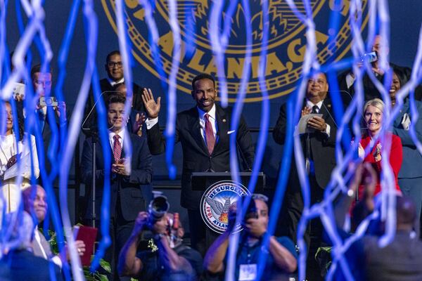 Confetti streams during Atlanta Mayor Andre Dickens’ (center) inauguration ceremony at the Georgia State University Convocation Center in Atlanta on Monday, Jan. 5, 2026. (Arvin Temkar/AJC)