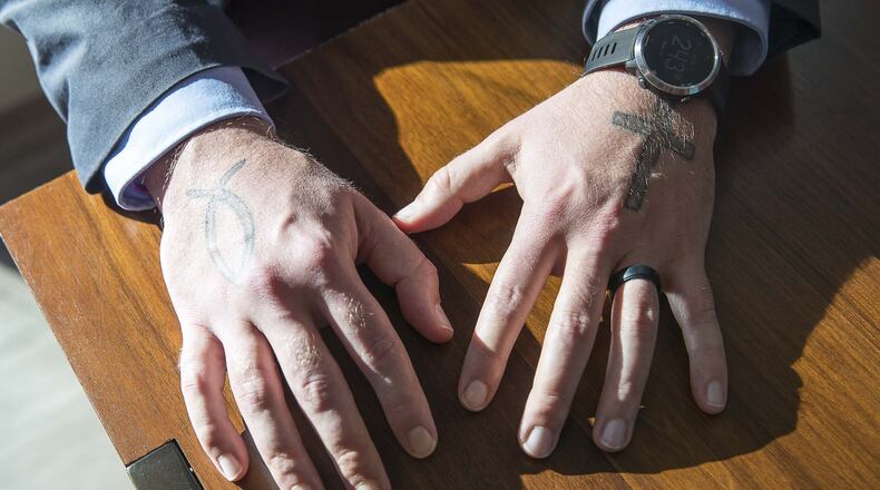 Michael Yandell, pastoral consultant with the Emory Healthcare Veterans Program, shows his tattoos in the Emory Healthcare Veterans Program suite at the Emory Health Brain Center in Atlanta, Wednesday, December 18, 2019. (ALYSSA POINTER/ALYSSA.POINTER@AJC.COM)