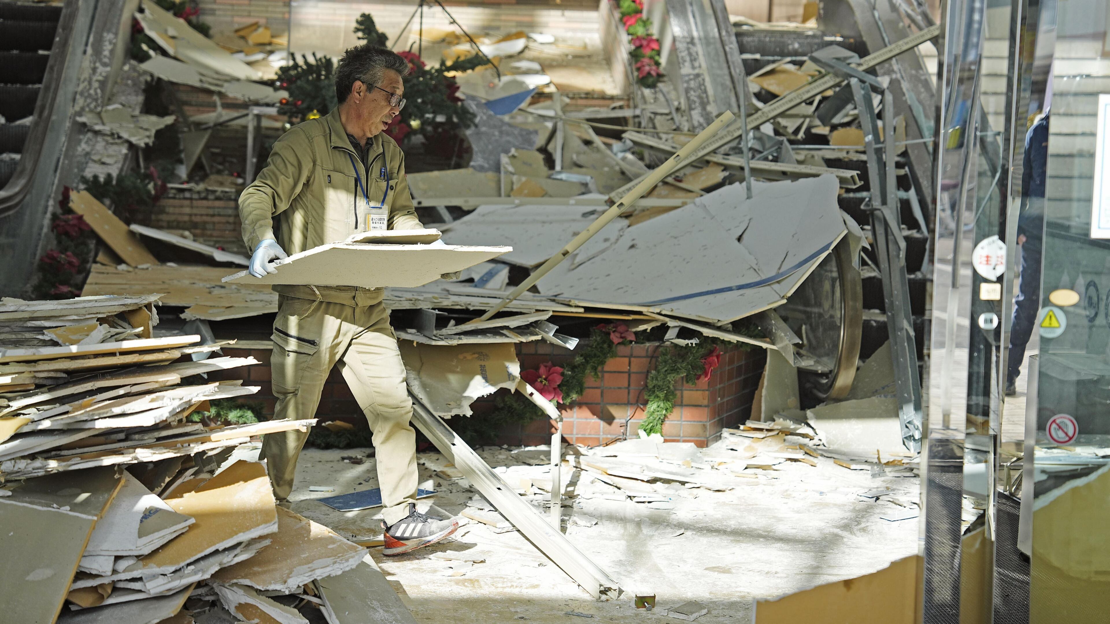 A man clears the debris from a powerful earthquake at a commercial facility in Hachinohe, Aomori prefecture, northern Japan Tuesday, Dec. 9, 2025. (Ren Onuma/Kyodo News via AP)