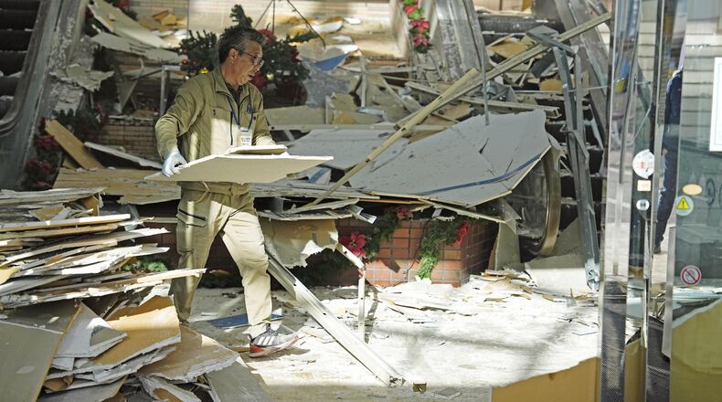 A man clears the debris from a powerful earthquake at a commercial facility in Hachinohe, Aomori prefecture, northern Japan Tuesday, Dec. 9, 2025. (Ren Onuma/Kyodo News via AP)