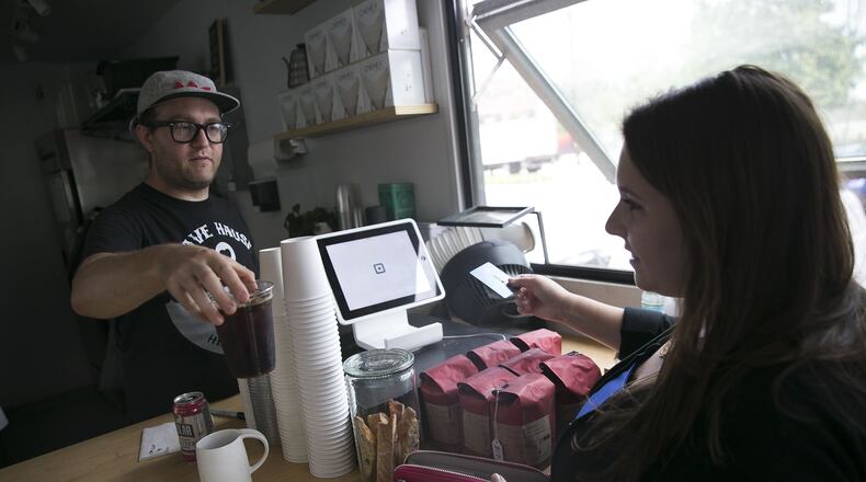 Rebecca Liebman, founder of a financial literacy site for millennials called LearnLux, pays for an iced coffee with her discover credit card at Triangle coffee in Boston, Aug. 12, 2016. Building a credit history holds less appeal for young Americans who had trouble paying off student loans and saw their families’ struggles during the financial crisis. (Katherine Taylor/The New York Times)