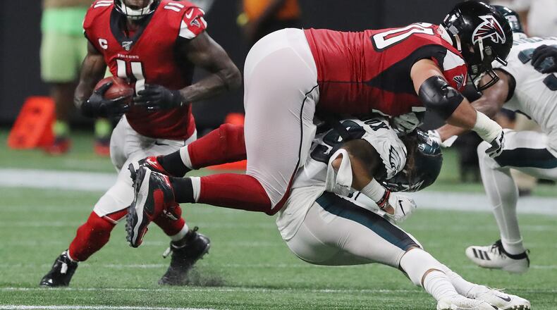 Falcons tackle Jake Matthews levels Philadelphia Eagles cornerback Avonte Maddox to free up wide receiver Julio Jones (left) for the long game winning touchdown.  Curtis Compton/ccompton@ajc.com