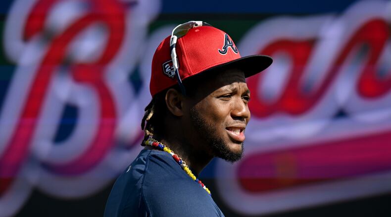 Atlanta Braves right fielder Ronald Acuna Jr. talks with teammates and coaching staff before taking batting practice during spring training workouts at CoolToday Park, Friday, February, 16, 2024, in North Port, Florida. (Hyosub Shin / Hyosub.Shin@ajc.com)