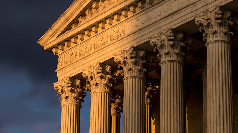 FILE - In this Oct. 10, 2017, file photo, the Supreme Court in Washington is seen at sunset. A flood of lawsuits over LGBT rights is making its way through the courts and will continue, no matter the outcome in the Supreme Court’s highly anticipated decision in the case of a Colorado baker who would not create a wedding cake for a same-sex couple. (AP Photo/J. Scott Applewhite, File)