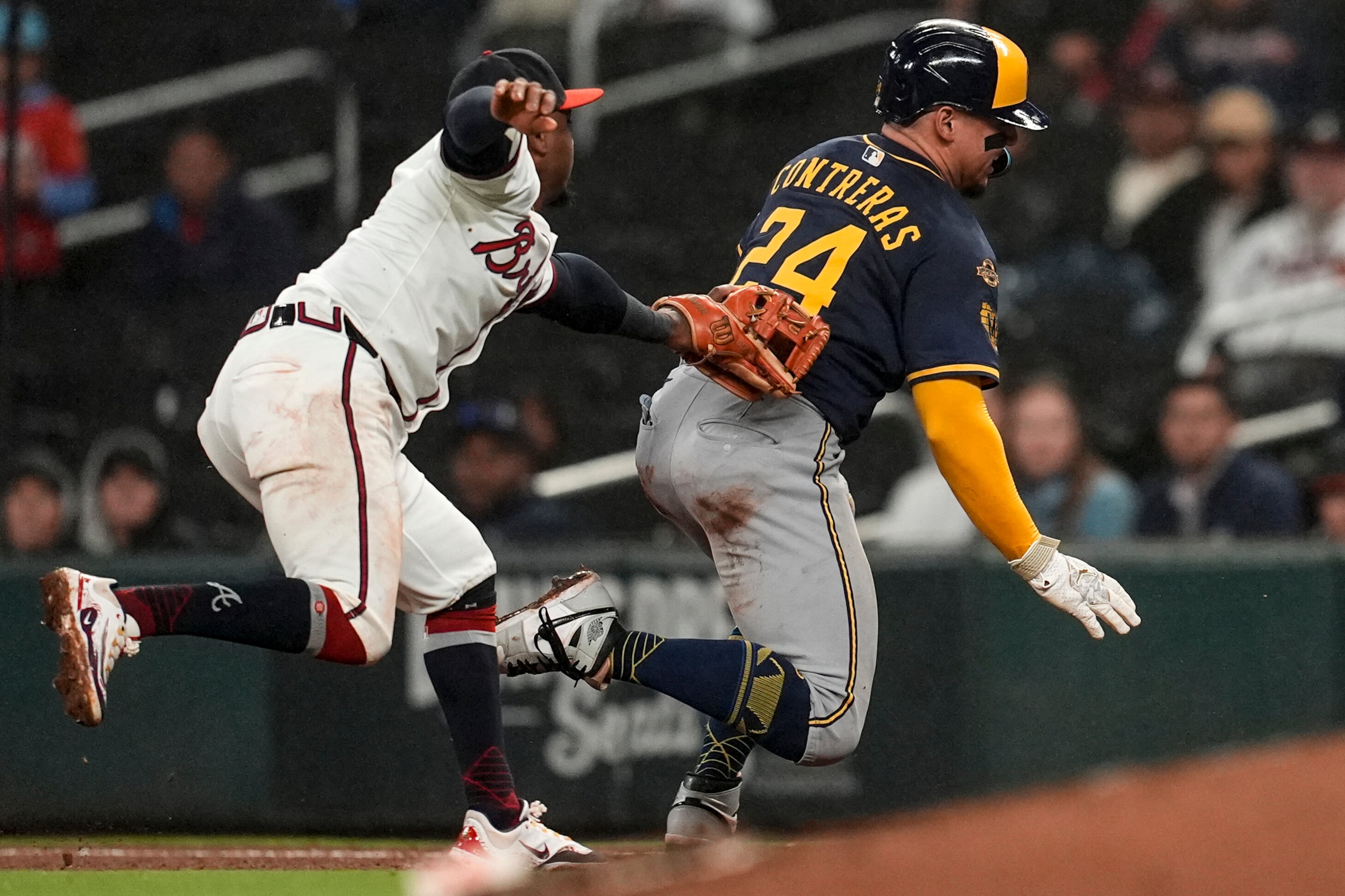 Atlanta Braves second baseman Ozzie Albies (1) works a run down against Milwaukee Brewers' William Contreras (24) in the eighth inning of a baseball game, Monday, Aug. 4, 2025, in Atlanta. (AP Photo/Mike Stewart)