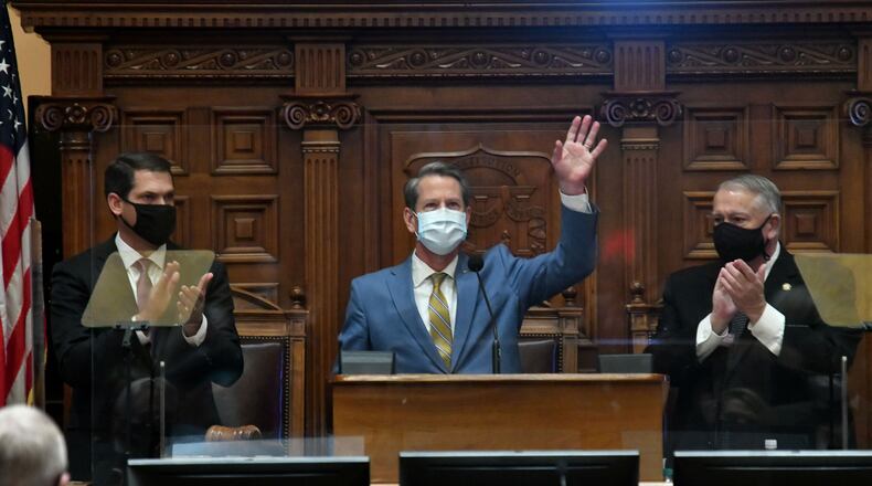 Gov. Brian Kemp, center, Lt. Gov. Geoff Duncan, left, and House Speaker David Ralston wear masks at the governor's State of the State address. The persistence of the coronavirus pandemic threatens to force a suspension of the legislative session for a second straight year. (Hyosub Shin / Hyosub.Shin@ajc.com)