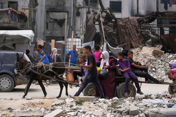 Displaced Palestinians fleeing Beit Lahia amid ongoing Israeli military operations in the Gaza Strip arrive in Jabalia, northern Gaza, on Sunday, May 18, 2025. (AP Photo/Jehad Alshrafi)