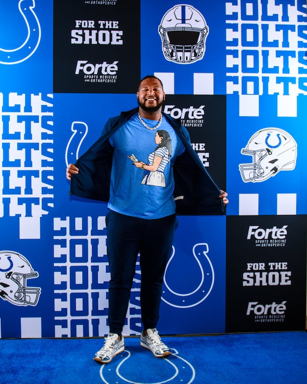 Indianapolis Colts defensive tackle Grover Stewart models a custom T-shirt with the image of team owner Carlie Irsay-Gordon. (Courtesy of Indianapolis Colts)