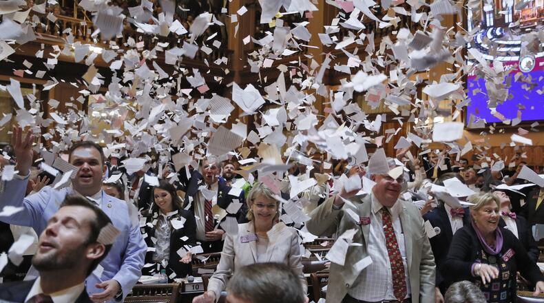 House members toss papers in the air as Sine Die was proclaimed shortly after midnight March 30. Lobbyists spent $483,466 on lawmakers during the session, mostly on food. BOB ANDRES /BANDRES@AJC.COM
