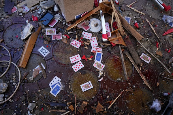 Blood, rubble, and a deck of cards lie scattered in a café after it was hit by an Israeli airstrike that killed more than 30 people near the port in Gaza City, Monday, June 30, 2025. (AP Photo/Jehad Alshrafi)