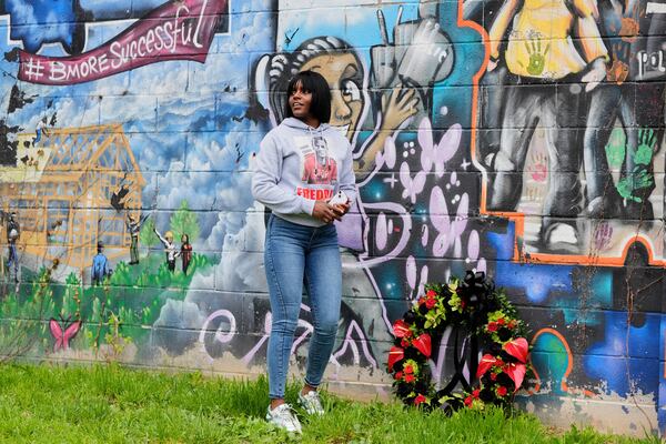Fredricka Gray, twin sister of Freddie Gray, lays a wreath at a mural during a memorial event commemorating the ten-year anniversary of her brother's death, Saturday, April 19, 2025, in Baltimore. (AP Photo/Stephanie Scarbrough)