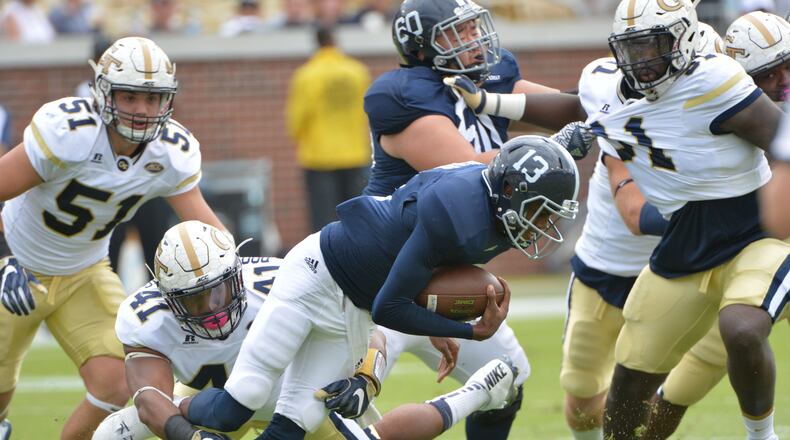 Georgia Southern quarterback Favian Upshaw (13) gets tackled by Georgia Tech defensive end Rod Rook-Chungong (41) in the first half at Bobby Dodd Stadium on Saturday, October 15, 2016. HYOSUB SHIN / HSHIN@AJC.COM