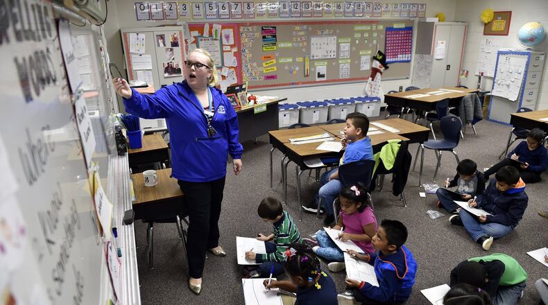 December 14, 2016, Norcross - Audrey Smith, 25, a first grade teacher at Baldwin Elementary School, draws a picture on the whiteboard for a class exercise in Norcross, Georgia, on Wednesday, December 14, 2016. Despite never having taught her own class before this year, Smith leads like a veteran teacher. (DAVID BARNES / DAVID.BARNES@AJC.COM)