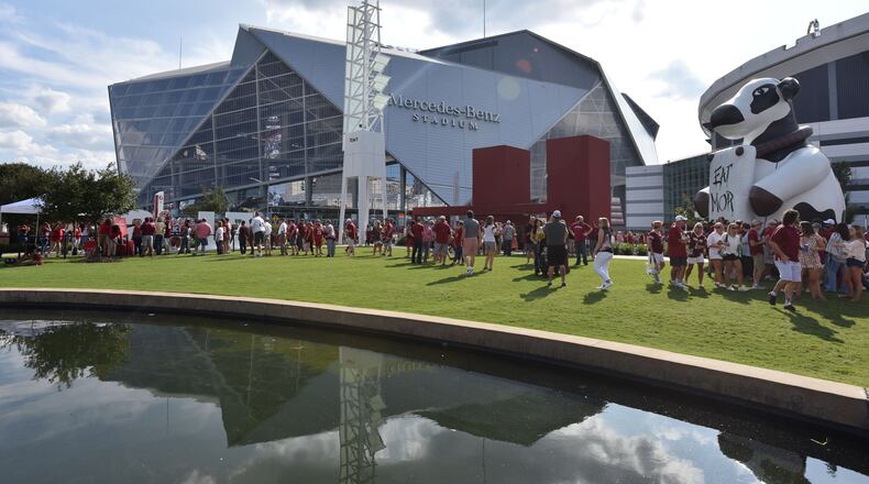 Fans tailgate outside the Mercedes-Benz Stadium before the 2017 Chick-Fil-A Kickoff game between Alabama and Florida State on Saturday, September 2, 2017. HYOSUB SHIN / HSHIN@AJC.COM
