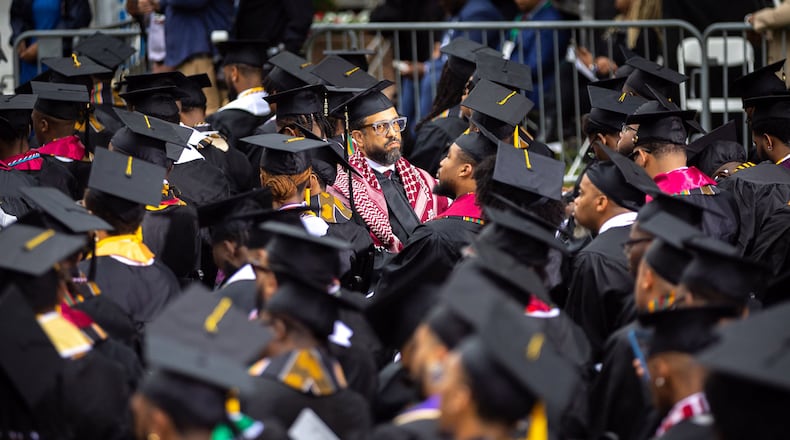 A Morehouse College graduate wears a keffiyeh and faces away from President Joe Biden to protest the war in Gaza during last year's commencement ceremony at the school in Atlanta. (Arvin Temkar/The Atlanta Journal-Constitution/TNS)
