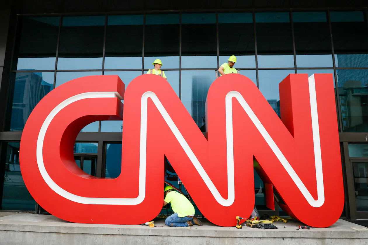 Crew personnel worked in March 2024, removing the bolts on the 12-foot, red-and-white iconic CNN sign outside of what was once CNN Center. (Miguel Martinez/AJC)