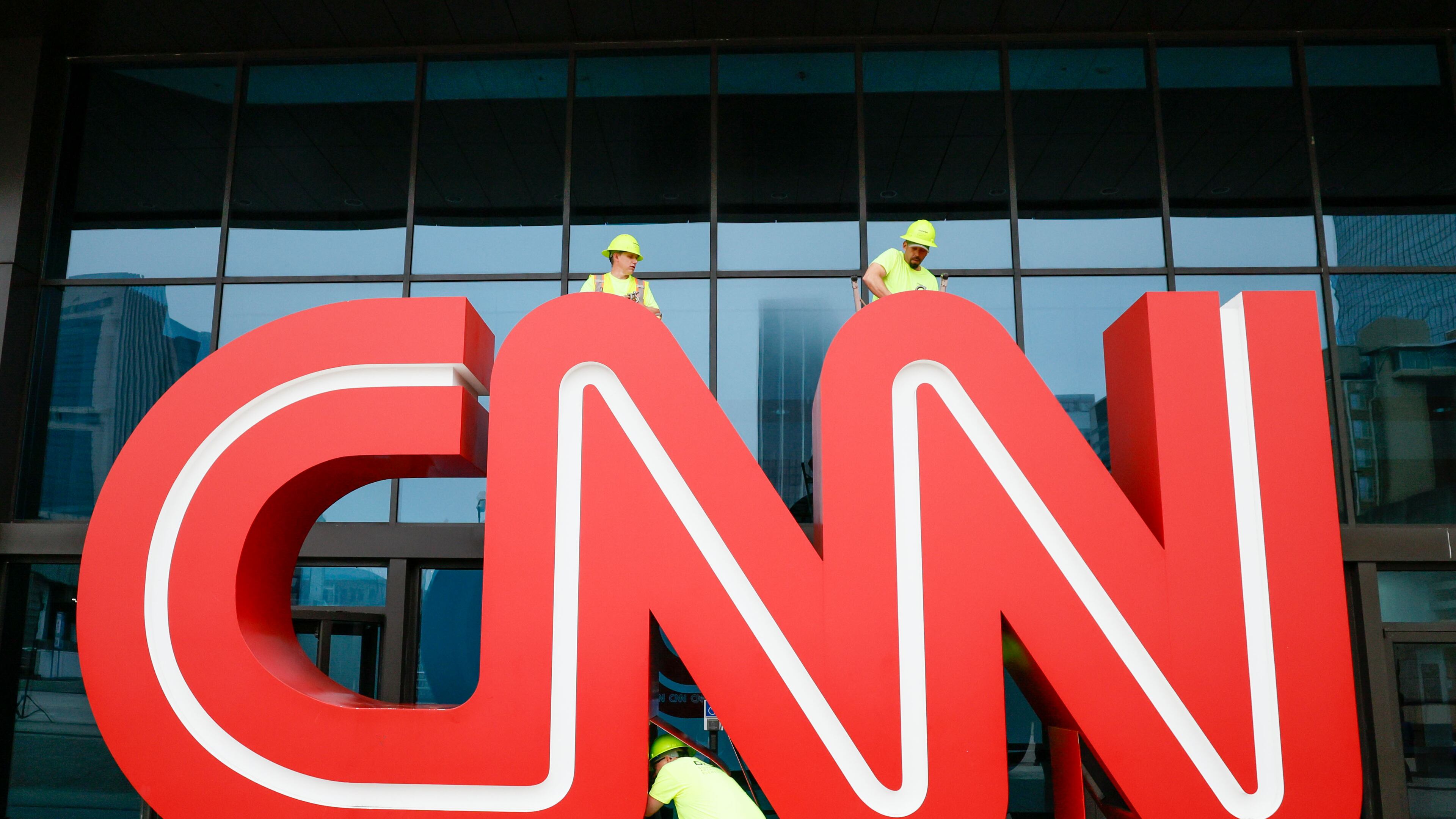 Workers remove the bolts on the 12-foot, red-and-white iconic CNN sign outside of what was once CNN Center, 2024. The news organization has since relocated its Atlanta operations to Techwood Drive. 
(Miguel Martinez/AJC)