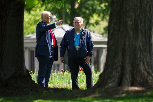 President Donald Trump, left, talks with Dale Haney, head White House groundskeeper, right, as he stands on the North Lawn of the White House in Washington, Wednesday, April 23, 2025, in Washington. (AP Photo/Mark Schiefelbein)