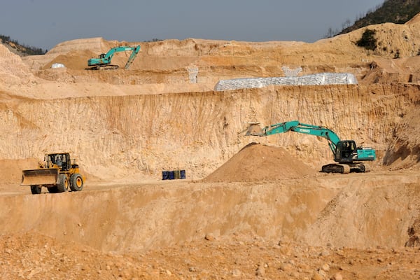 FILE - Workers use machinery to dig at a rare earth mine in Ganxian county in central China's Jiangxi province on Dec. 30, 2010. (Chinatopix via AP, File)