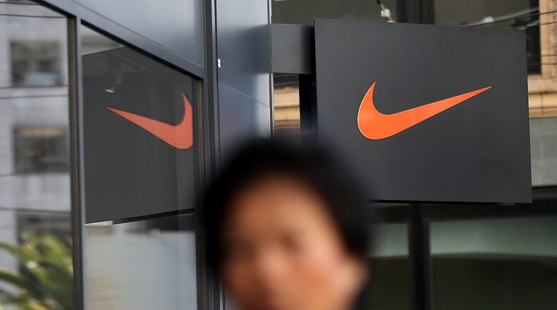 SAN FRANCISCO, CA - MARCH 22: A pedestrian walks by a Nike store on March 22, 2016 in San Francisco, California. Nike Inc. will announce third-quarter earnings after the closing bell. (Photo by Justin Sullivan/Getty Images)