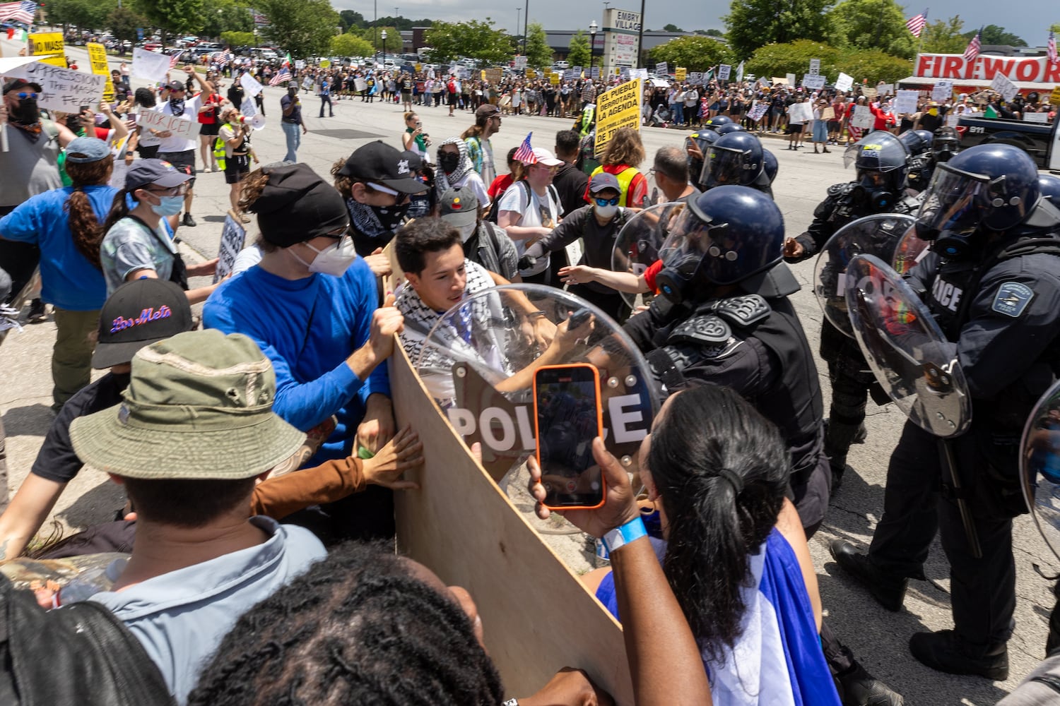 Police advance on demonstrators during a protest on ICE raids and deportation arrests on Chamblee Tucker Road in Atlanta on Saturday, June 14, 2025. (Arvin Temkar / AJC)