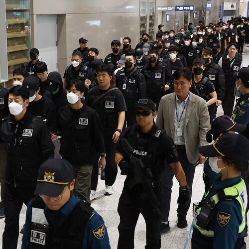 FILE - South Koreans, walking in the line to the left, who are allegedly involved in online scams in Cambodia arrive at the Incheon International Airport, in Incheon, South Korea, Oct. 18, 2025. (Yonhap via AP, File)