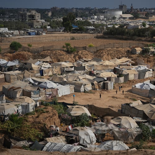 Palestinian children play in an open area at a makeshift camp for displaced people in Deir al-Balah, central Gaza Strip, Friday, Aug. 7, 2026. (AP Photo/Abdel Kareem Hana)