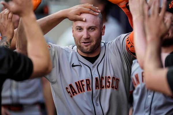 San Francisco Giants' Casey Schmitt (10) celebrates his solo home run against the Atlanta Braves in the second inning of a baseball game, Tuesday, July 22, 2025, in Atlanta. (AP Photo/Mike Stewart)