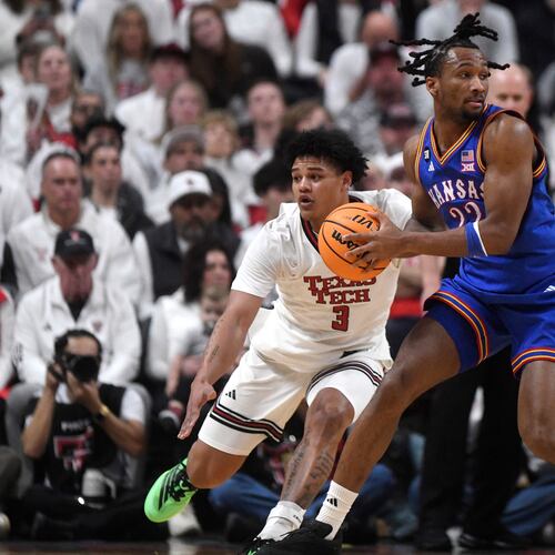 Texas Tech forward Lejuan Watts (3) attempts to guard Kansas guard Darryn Peterson (22) during the first half of an NCAA college basketball game, Monday, Feb. 2, 2026, in Lubbock, Texas. (AP Photo/Annie Rice)