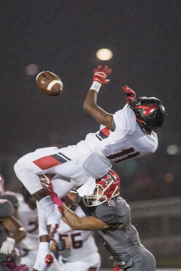Alexander High School player Justin Hall (11) tries unsuccessfully to make a catch while being defended by Allatoona High School player Raleigh Webb (2) during the first half of a high school football game, Friday, Oct. 2, 2015, in Acworth, Ga. BRANDEN CAMP/SPECIAL
