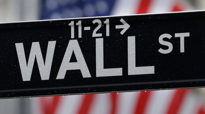 This July 9, 2015 photo shows a Wall Street sign near the New York Stock Exchange in New York. Stock markets turned lower in European trading on Thursday, April 7, 2016 as a rebound in oil prices ran out of steam. (AP Photo/Seth Wenig)